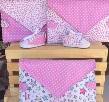 Pink themed baby shoes and clutch bags